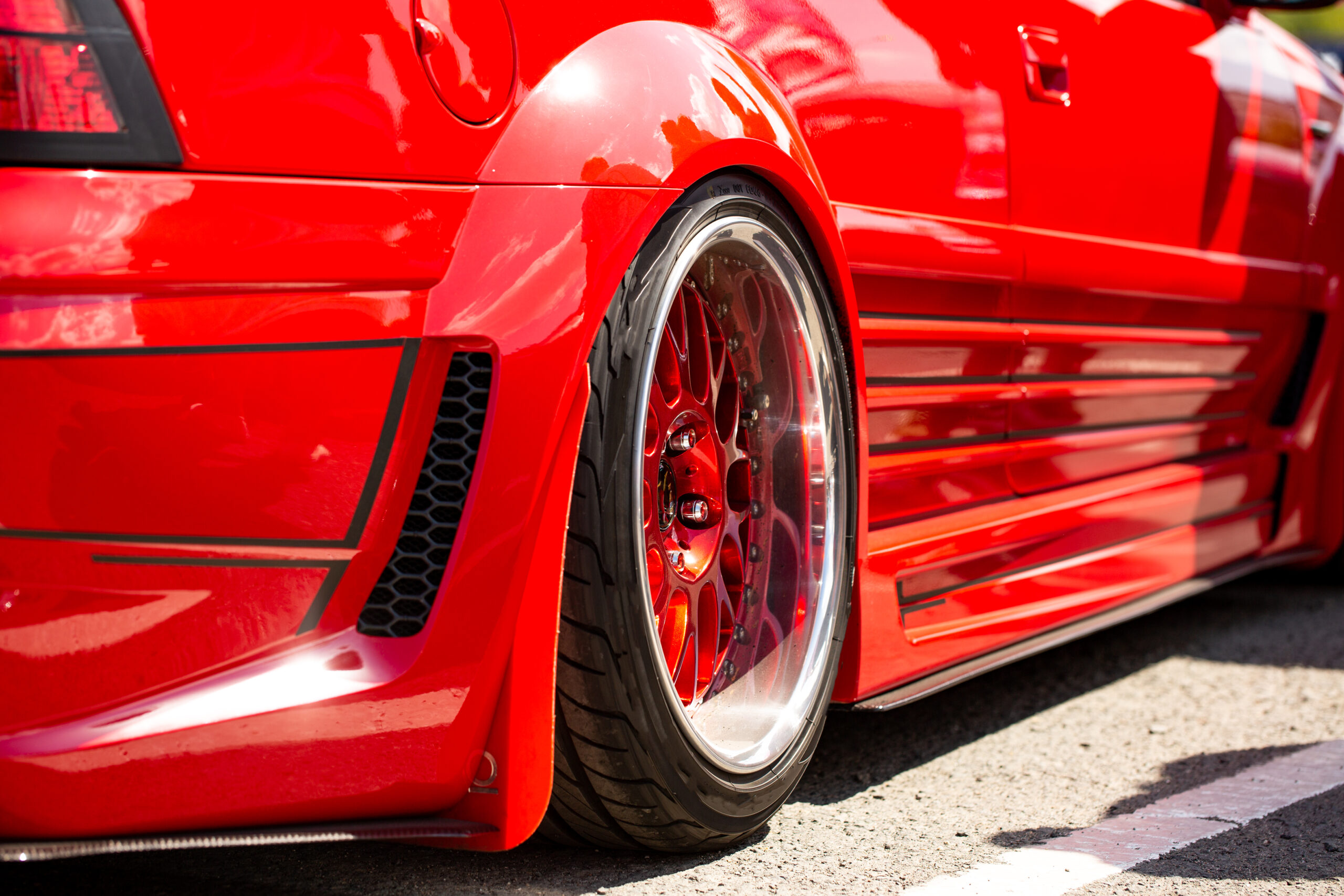 Red sports tuned car rear view of the wheel, close up . Red sports tuned car rear view of the wheel, close up .